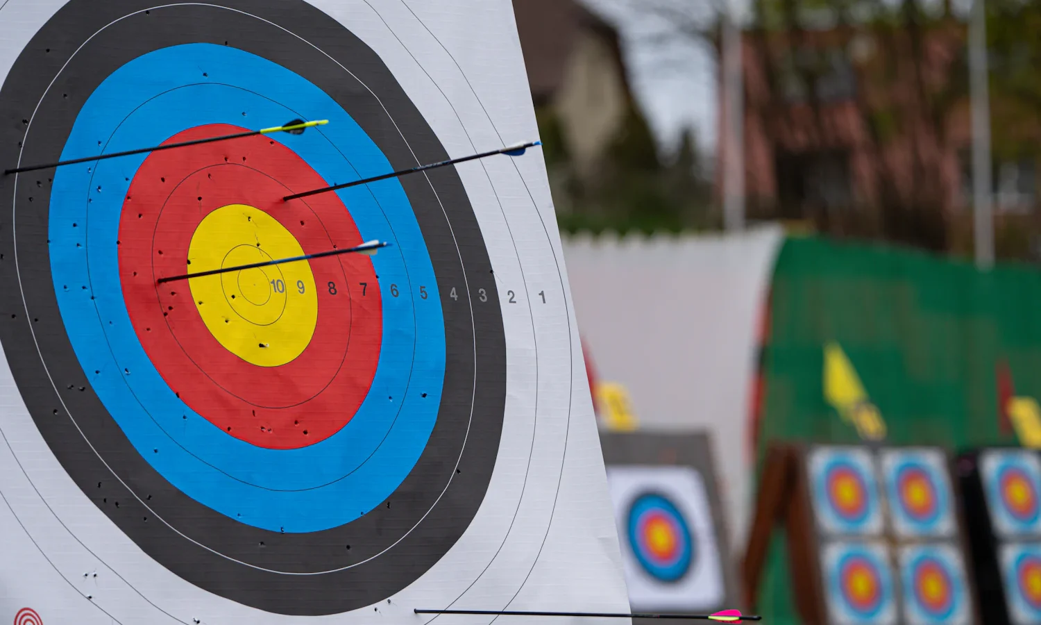 Close-up of an archery target face with more targets in the background