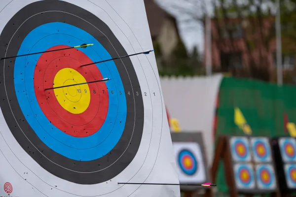 Close-up of an archery target face with more targets in the background