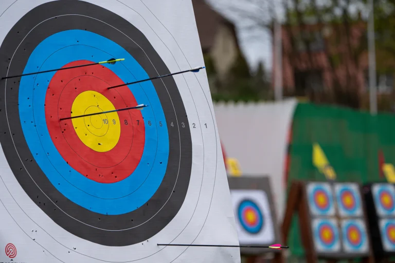 Close-up of an archery target face with more targets in the background