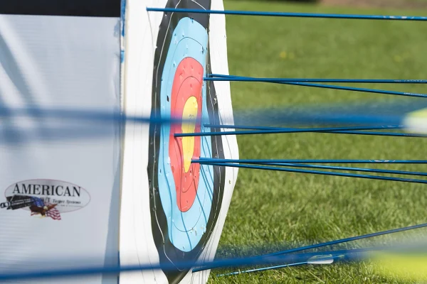 Arrow shafts standing out from a target face at an archery tournament