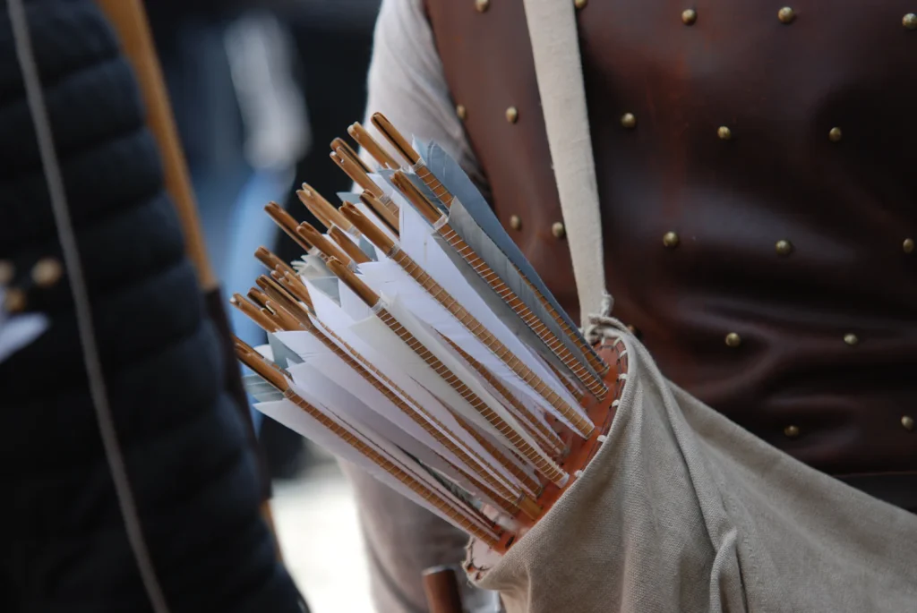 Arrows with feather fletching carried in a leather quiver