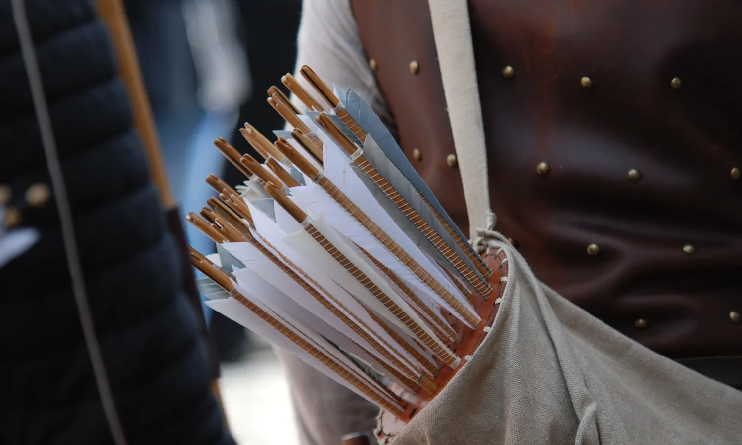 Arrows with feather fletching carried in a leather quiver