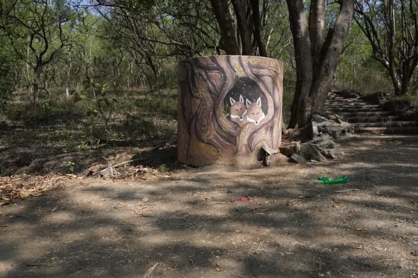 Painted animal target on a round bale at a woodland archery course
